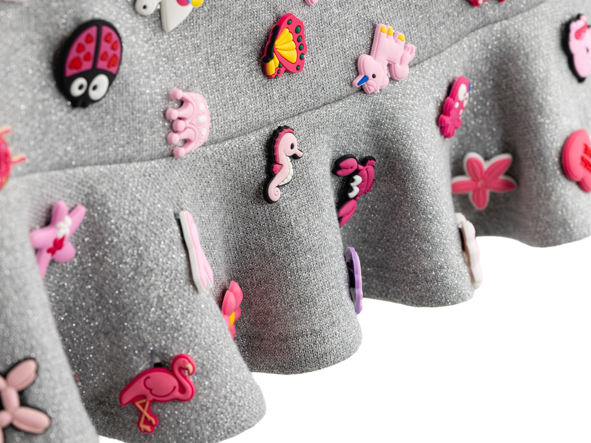 Detail of the ruffle hem and charms on the charm mini skirt