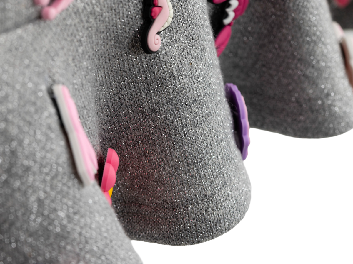 Charm mini skirt detail, pink charms on soft grey fabric