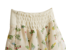 Shirred waist detail on the cream floral mini skirt