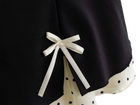 Satin ribbon bow detail on the black polka dot mini skirt