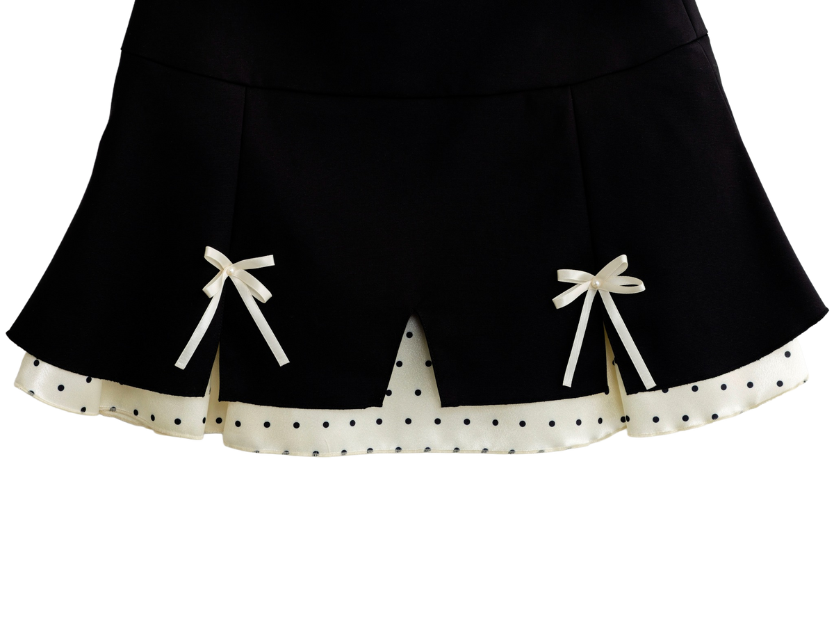 Close up of the polka dot trim on the black mini skirt