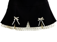 Close up of the polka dot trim on the black mini skirt