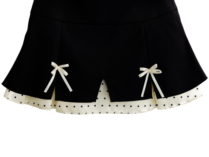 Close up of the polka dot trim on the black mini skirt