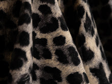 Detail of the rhinestone buckle belt on the leopard print skirt