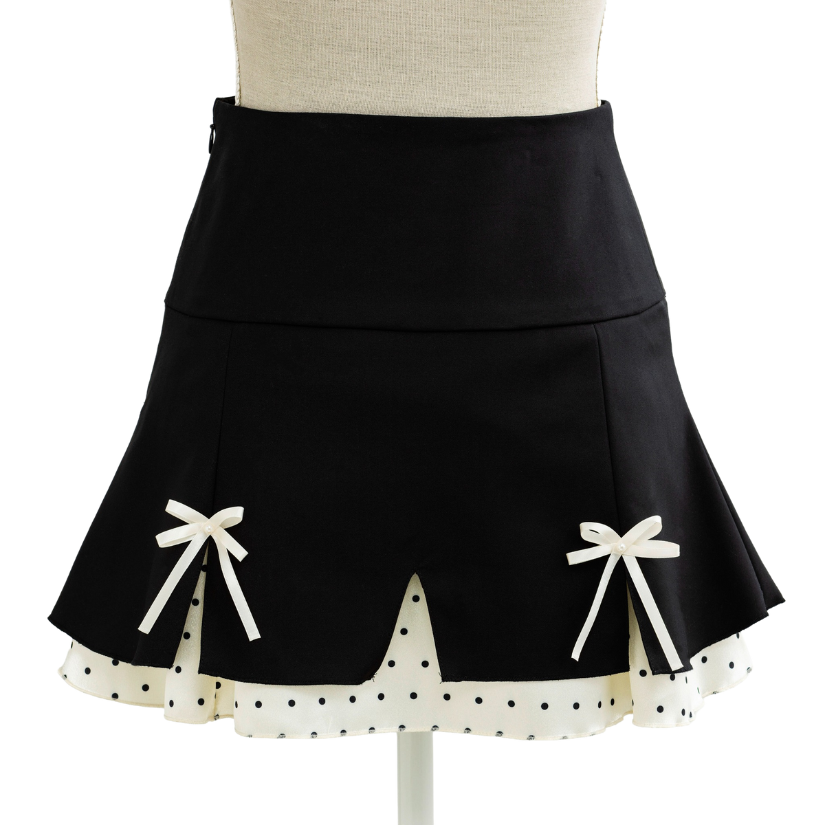 Black coquette mini skirt with white bows and a scalloped dotted hem