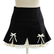 Black coquette mini skirt with white bows and a scalloped dotted hem