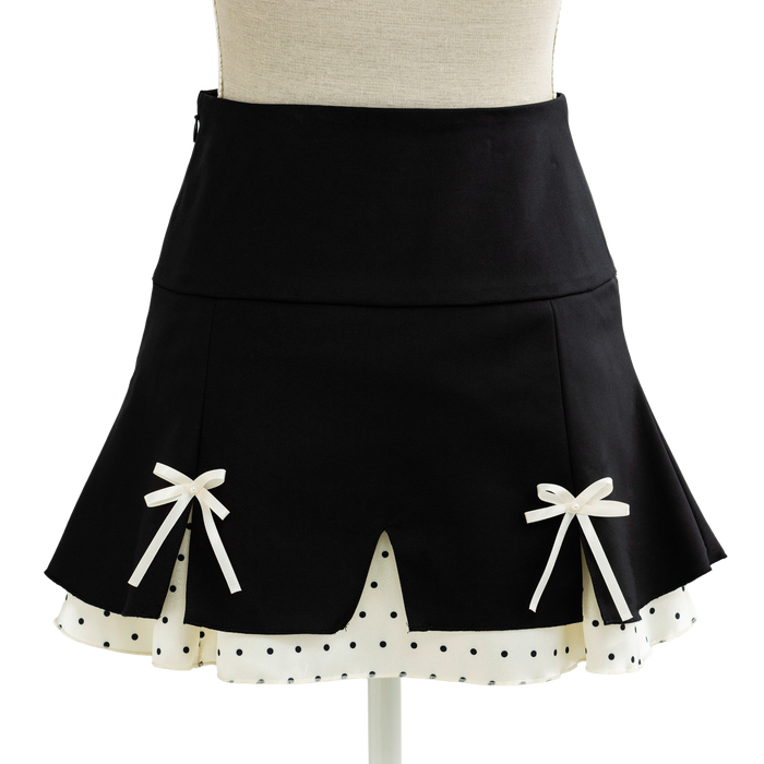 Black coquette mini skirt with white bows and a scalloped dotted hem