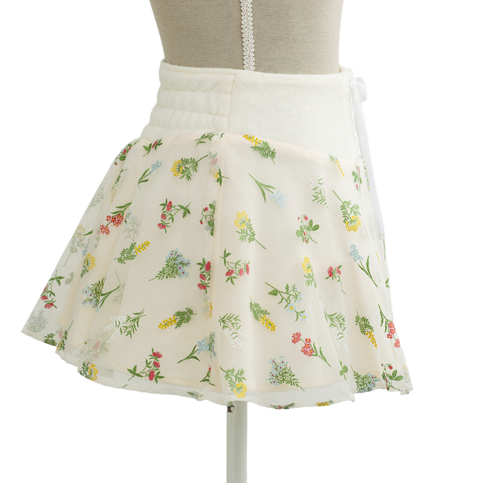 Floral print mini skirt in cream, flared shape on a mannequin