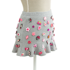 Charm mini skirt in grey with pink charms, styled on a mannequin