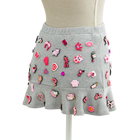 Back view of the coquette charm mini skirt covered in pink charms