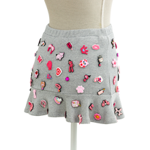Back view of the coquette charm mini skirt covered in pink charms