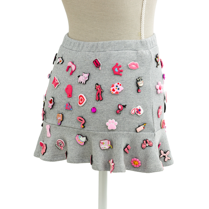 Back view of the coquette charm mini skirt covered in pink charms
