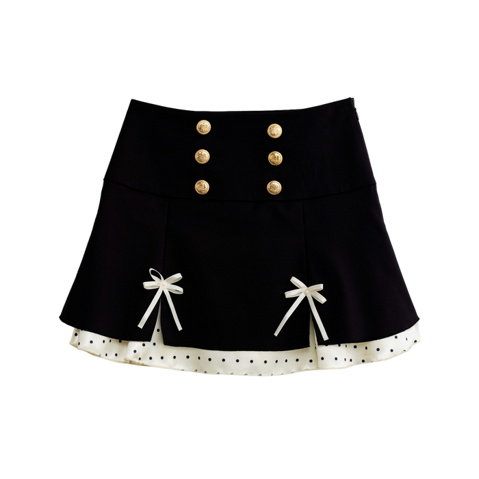 Black polka dot mini skirt with satin ribbon bows, front view