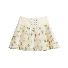 Cream floral mini skirt with a lace-up waist, front view