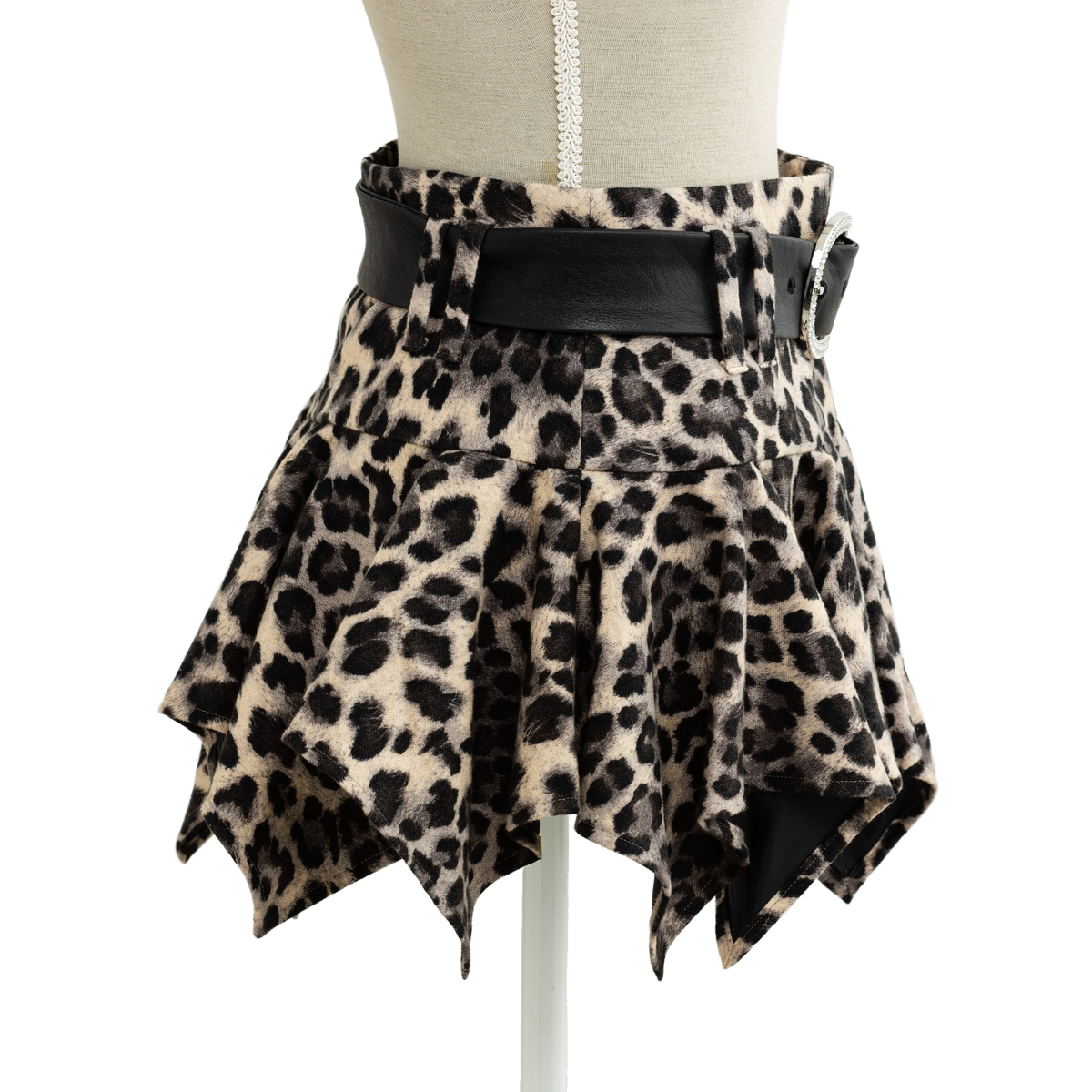 Leopard print mini skirt styled on a mannequin, pointed asymmetric hem