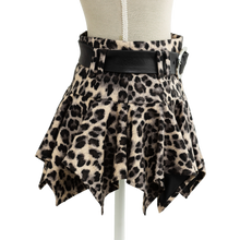 Leopard print mini skirt styled on a mannequin, pointed asymmetric hem